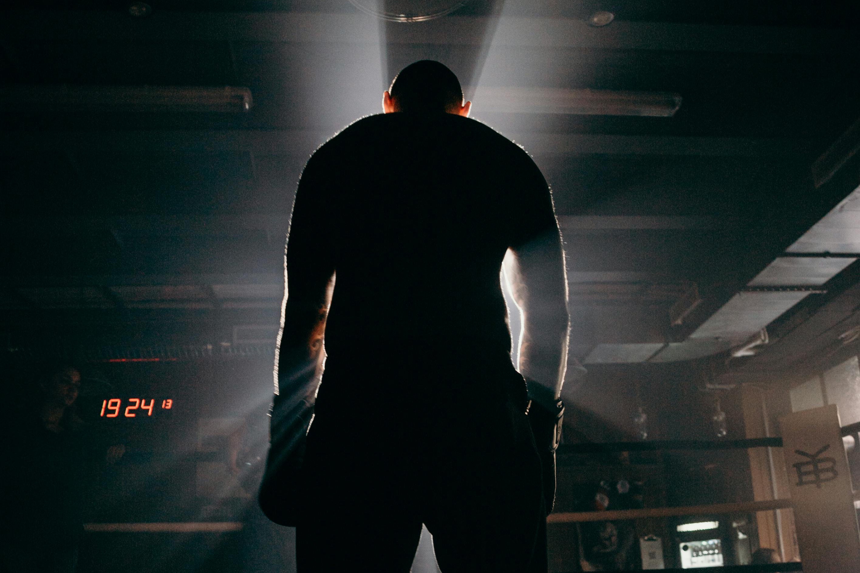 Boxing gym with boxing ring, boxing gloves, boxing pads, punching bags.